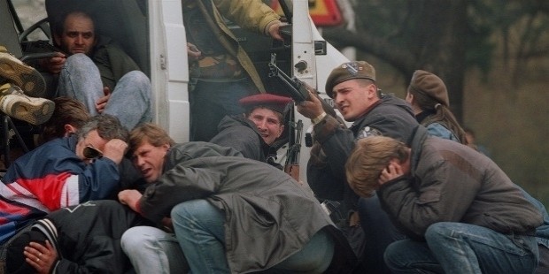 a bosnian special forces soldier returns fire in downtown sarajevo as he and civilians come under fire from serbian snipers on april 6 1992