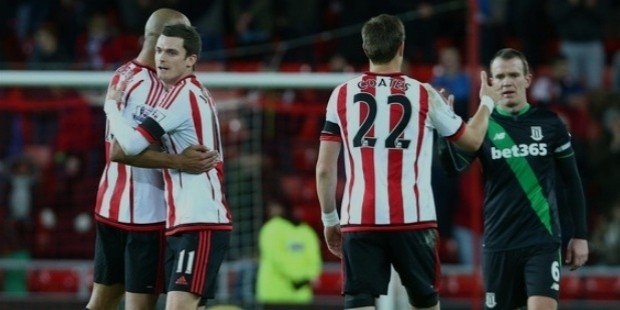 adam johnson of sunderland celebrates with younes kaboul at the end of the game