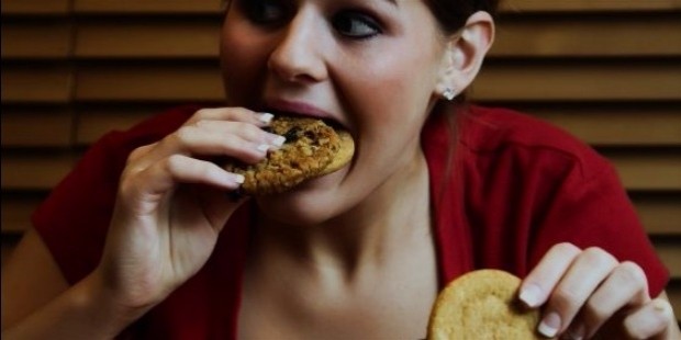 girl in red eating cookies