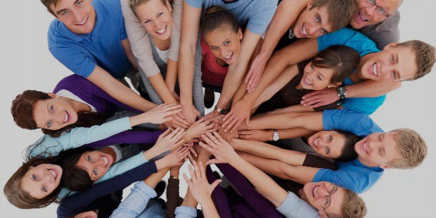 group of people with hands in middle