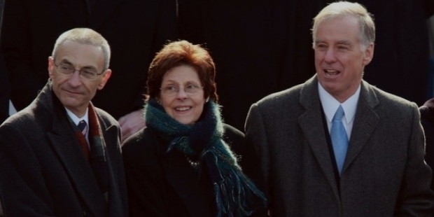 john podesta  l  and howard dean  r  stand on the inaugural platform before the inauguration of barack obama 