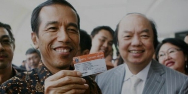 jokowi widodo  left  holds up a jakarta health card  kjs  besides mayapada group founder dato sri tahir