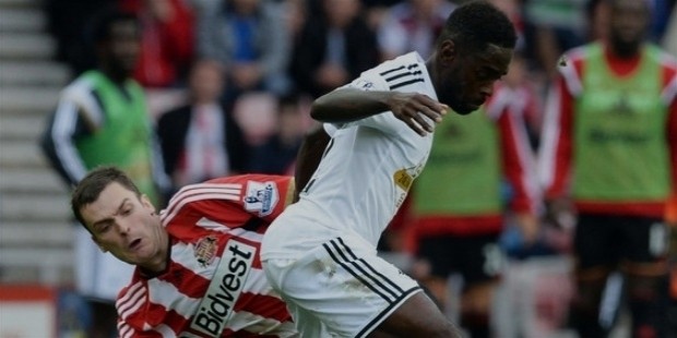 nathan dyer of swansea city is tackled by adam johnson of sunderland