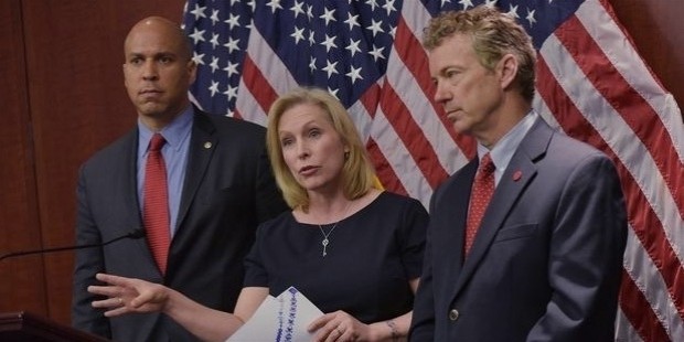 senator kirsten gillibrand, d ny, flanked by senator cory booker  l , d nj, and senator rand paul,