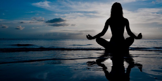 woman meditating ocean