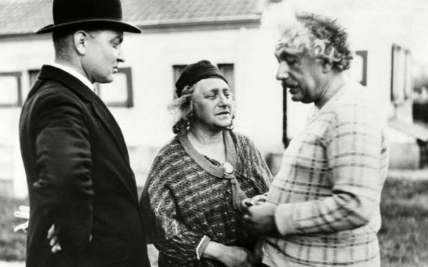 Albert Einstein and his wife Elsa talking to a Belgian policeman in 1933