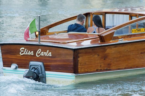The Copule on boat roaming Venice