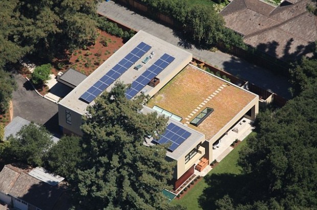 The 9,200sq ft home features a huge basement, waterfall, solar panels and a 'living roof' 