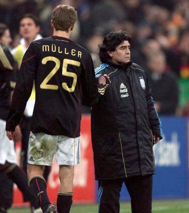 Thomas Muller shaking hands with Football legend Maradona
