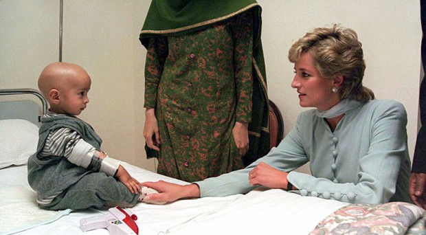 The Princess of Wales talks to a young child at the Shaukat Khanum Memorial Cancer Hospital