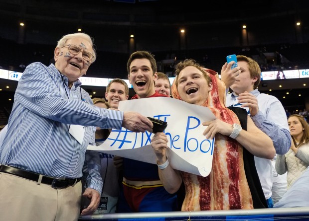 Warren Buffet Givinh His Wallet to a Fan during a Game