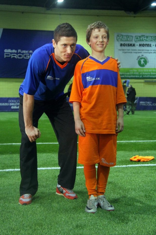 Lewy with a young kid at Hall football