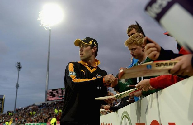 Signing Autographs to his fans during a match