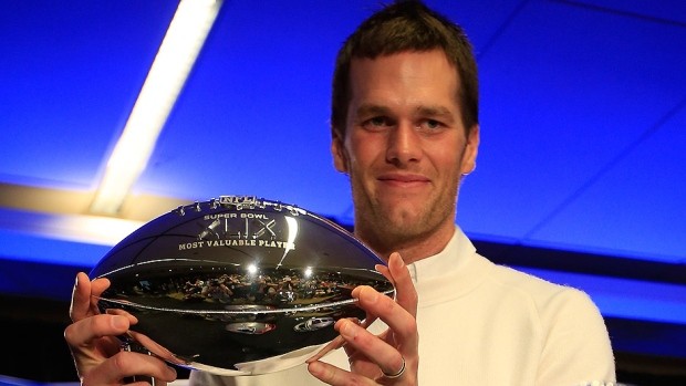 Tom Brady holds the Super Bowl MVP trophy 