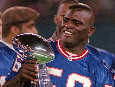 Lawrence Taylor poses with the Lombardi Trophy
