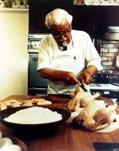 Colonel Sanders cutting chicken